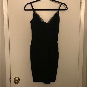 A mid-thigh black dress